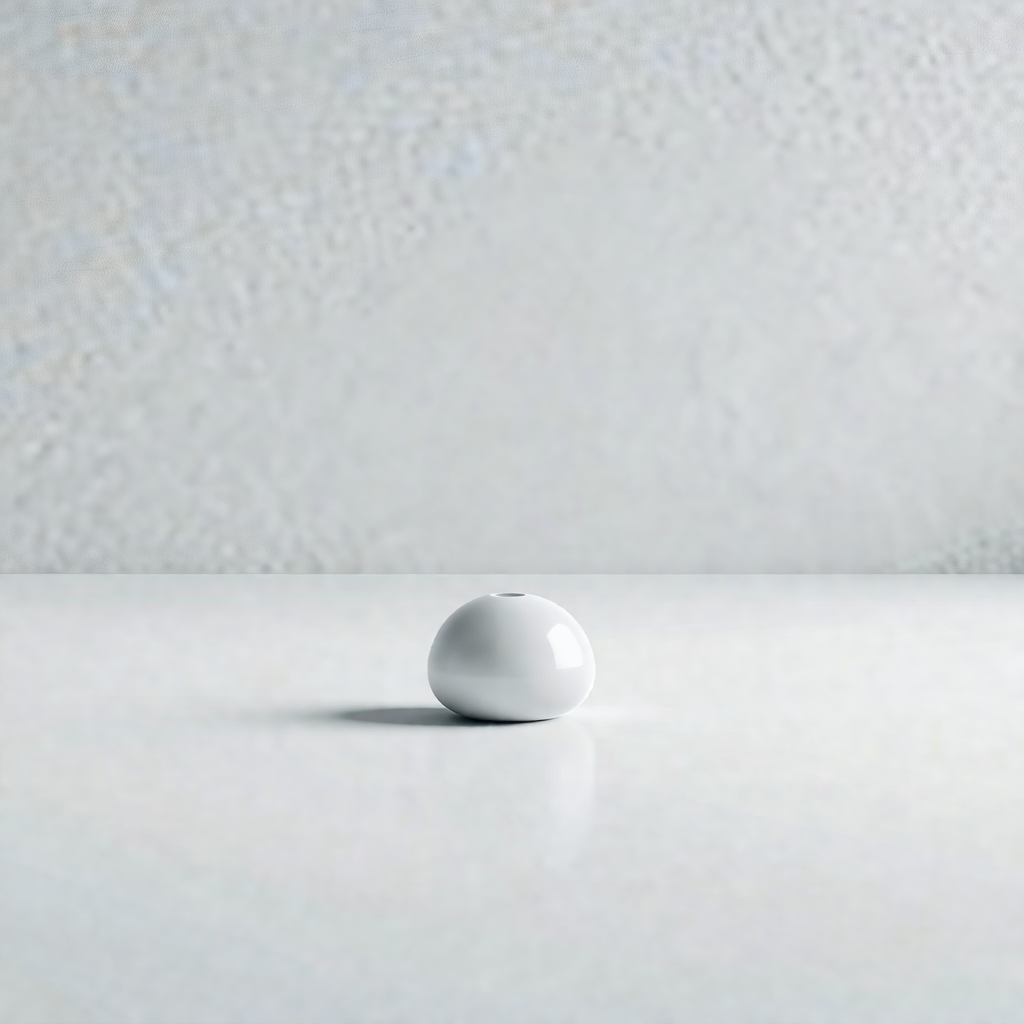 White wall with a small white ball placed on it
