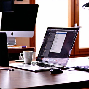 Business Commercial Photography: Workplace with laptop and coffee on desk