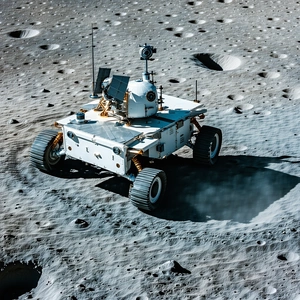 A White Robotic Vehicle Is Driving On A Rocky Surface, Possibly On The Moon