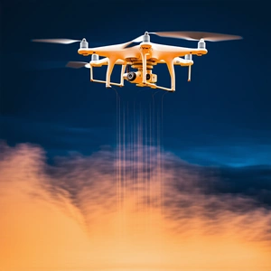 A Yellow Drone Is Flying Through The Sky, With A Cloudy Orange Background