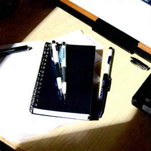 Business Macro Photography: Workplace With Notebooks And Pens On Desk With Wooden Desk