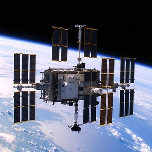 A Space Shuttle With A Large Number Of Solar Panels On Its Side