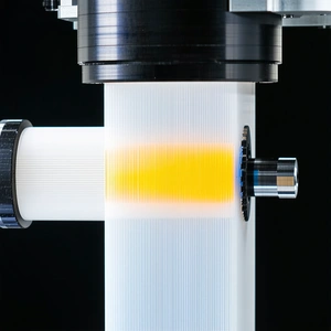 A White Tube Is Filled With A Yellow Substance, Which Appears To Be A Lighted Fluid