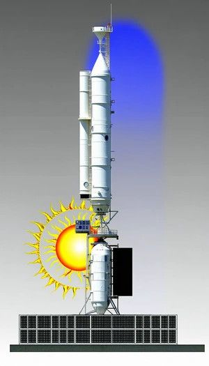 A Large White Tower With A Yellow Sun In The Center