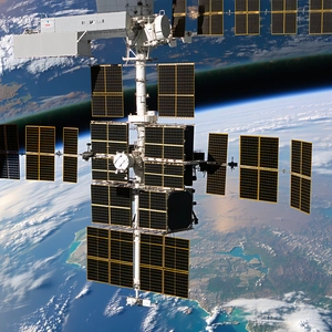 A Space Shuttle Is Seen From Below, With Its Solar Panels And Other Equipment Clearly Visible