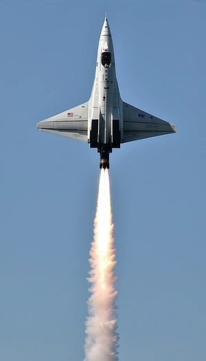 A Fighter Jet Is Flying Through The Sky, Leaving A Trail Of Smoke Behind It