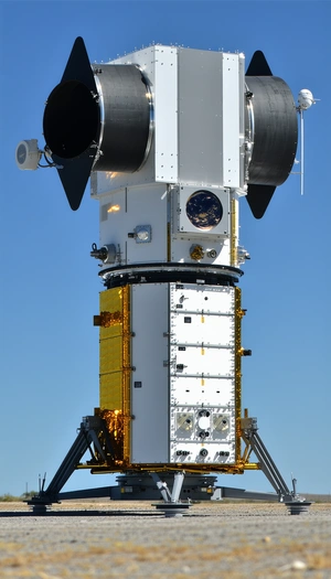 A Large White Satellite Is Sitting On Top Of A Tall Tower