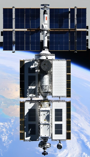 A Large White Spacecraft Is Docked With A Space Station