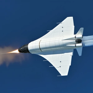 A White Jet Is Flying Through The Sky, Leaving A Trail Of Smoke Behind It