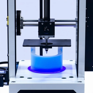 A Machine Is Shown In The Image, With A Blue Object On Top Of It