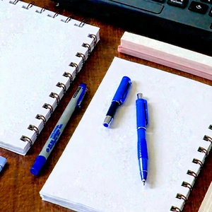 Business Macro Photography: Workplace with notebooks and pens on desk
