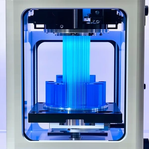 A Large, Blue, Three-dimensional Printer That Is In The Process Of Printing A Blue Object