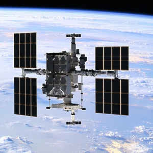 A Space Shuttle With A Large Satellite On Top Of It