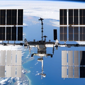 A Space Shuttle With Its Solar Panels Open, Floating In The Sky