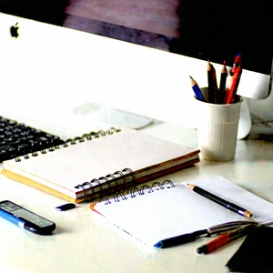Business Tilt-Shift Photography: Workplace with notebooks and pens on desk