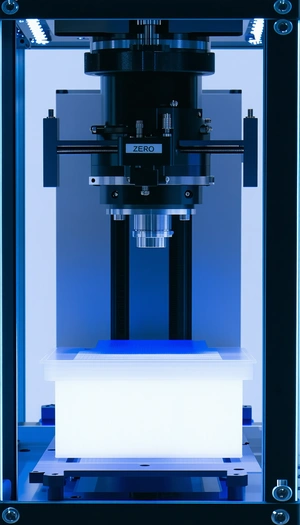 A Black And Blue Machine With A Large Lens On Top