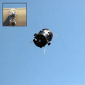A Satellite Is Flying High In The Sky, With A Clear Blue Sky As The Backdrop