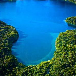 Nature Aerial Photography: Crystal clear lake surrounded by lush vegetation