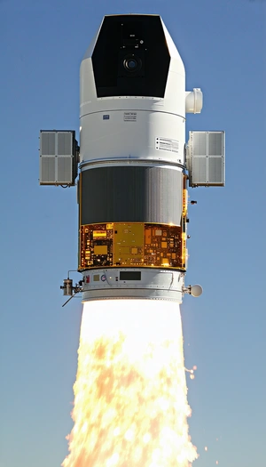 A Rocket Is Seen In The Sky, With Its Tail End Visible