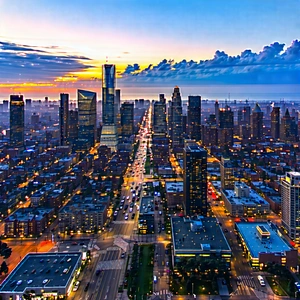 Urban Drone Photography: Cityscape Of Downtown District During (sunset:1.29) With Nighttime View