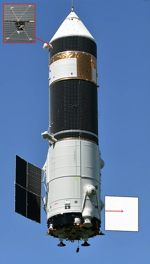 A Large White Satellite Dish Mounted On A White Tower