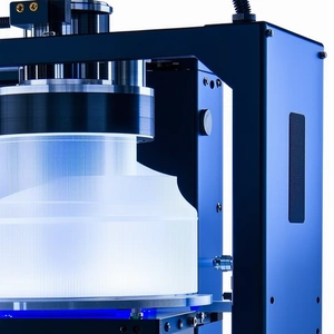 A Large Blue Machine Is Sitting On A White Surface