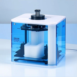 A Blue And White Machine Is Sitting On A White Table