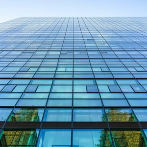 Urban Commercial Photography: Glass Office Tower With Artistic Facade With Tall Building