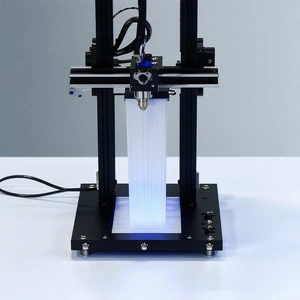 A Large, Black, And Metal Machine With A Blue Light On It