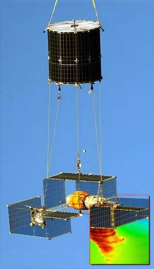 A Large Satellite Dish Suspended In The Air, With A Space Shuttle Attached To It