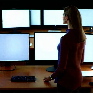 Business Advertising Photography: Education professional using multiple monitors