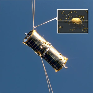 A Satellite Is Being Transported Through The Air By A Cable