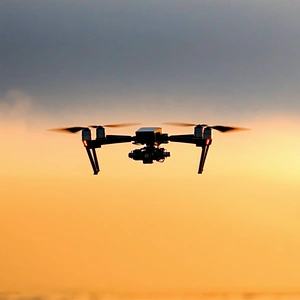 A Drone Is Flying In The Sky, Capturing The Sunset