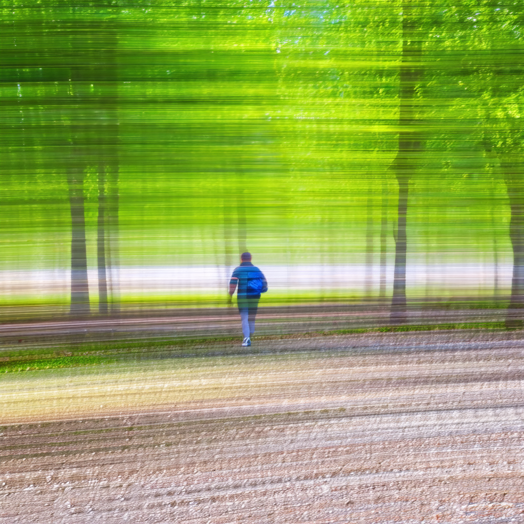Blurry photo of a man walking through a forest