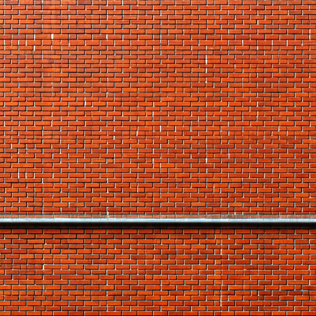 Red brick wall with a pipe running along the top