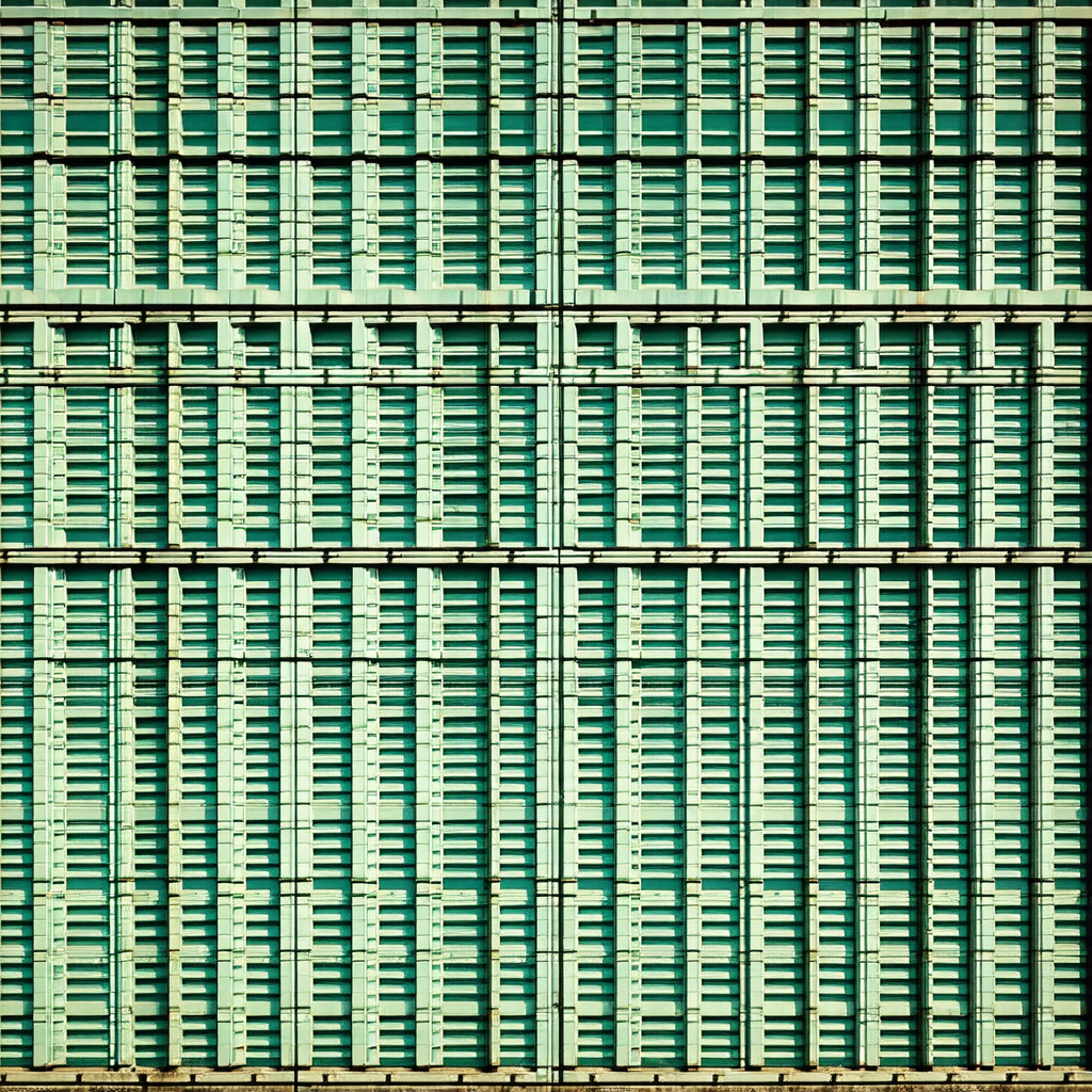 Large, green, and white building with a patterned wall