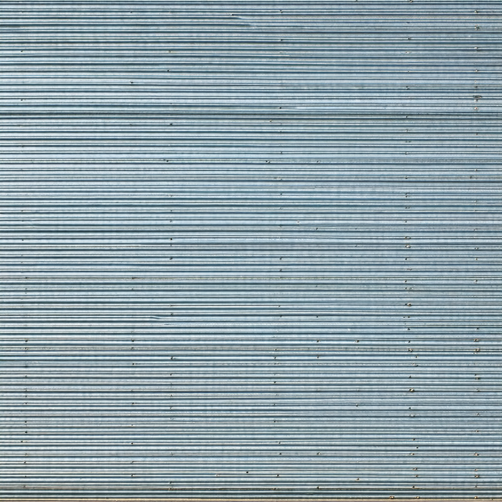 Large blue metal wall with a row of silver bolts running ...