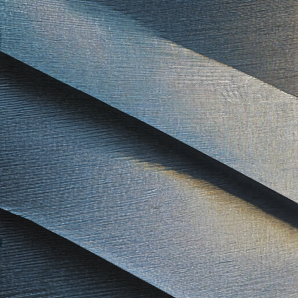 Large, shiny metal surface with a blue tint