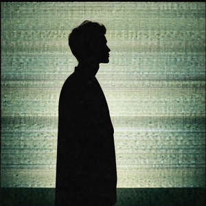 Man standing in front of a green background