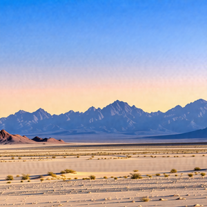Vast, open desert landscape with a mountain range in the ...