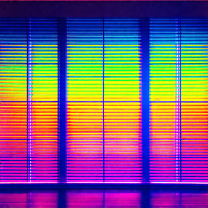Large window with a row of colorful lights lined up along...